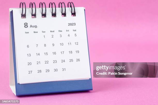 calendar desk 2023: august is the month for the organizer to plan and deadline with a pink paper background. - august stock pictures, royalty-free photos & images