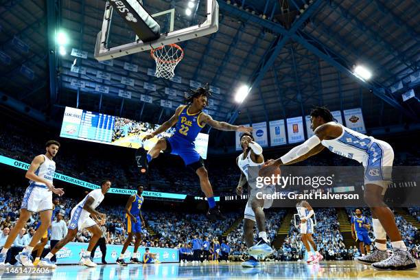 Nike Sibande of the Pittsburgh Panthers battles Leaky Black and Caleb Love of the North Carolina Tar Heels for a rebound during the first half of...