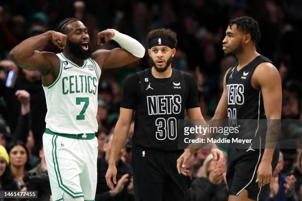 Jaylen Brown of the Boston Celtics celebrates in front of Cam Thomas and Seth Curry of the Brooklyn Nets after scoring during the first half at TD...