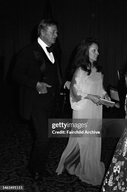 Actor John Wayne with wife Pilar Pallete attending a Harvard alumni fund raising dinner at the Beverly Hilton Hotel