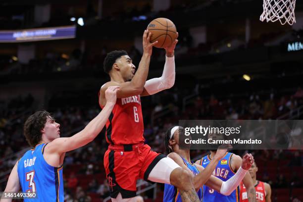 Kenyon Martin Jr. #6 of the Houston Rockets drives to the net ahead of Josh Giddey of the Oklahoma City Thunder during the first half at Toyota...