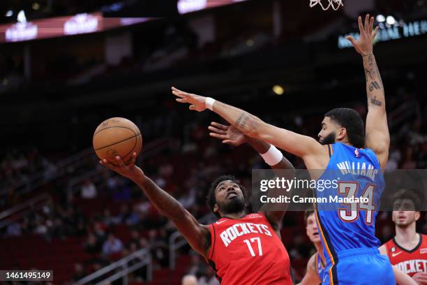 Tari Eason of the Houston Rockets drives to the net against Kenrich Williams of the Oklahoma City Thunder during the first half at Toyota Center on...