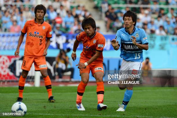 Yutaka Yoshida of Shimizu S-Pulse controls the ball against Minoru Suganuma of Jubilo Iwata during the J.League J1 match between Jubilo Iwata and...