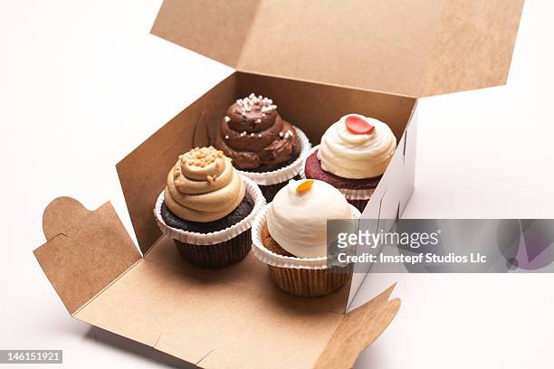 four cupcakes - cupcake box stock pictures, royalty-free photos & images