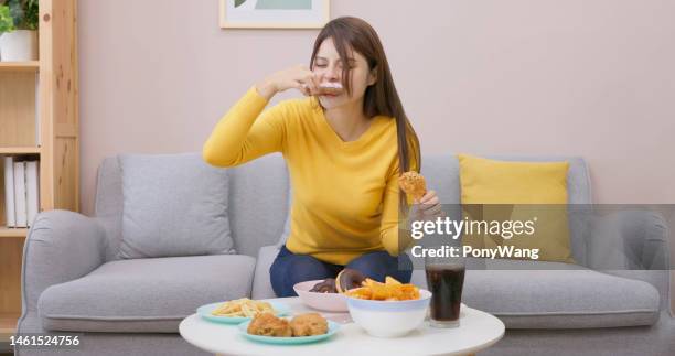 ragazza asiatica che mangia troppo - fat people eating donuts foto e immagini stock