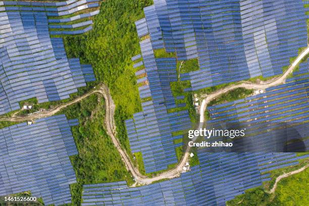 looking down on the hilltop solar power plant - westernization stock pictures, royalty-free photos & images