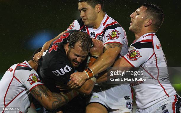 Clint Newton of the Panthers is tackled during the round 14 NRL match between the Penrith Panthers and the New Zealand Warriors at Centrebet Stadium...