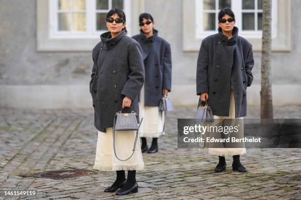 Three guests are wearing black sunglasses, a white latte long fringed dress, a gray high neck / buttoned wool coat, a black and white houndstooth...