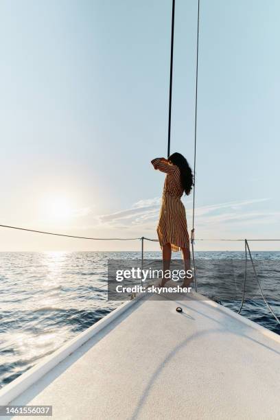 back view of a woman traveling in summer day on a yacht. - ship's bow stock pictures, royalty-free photos & images