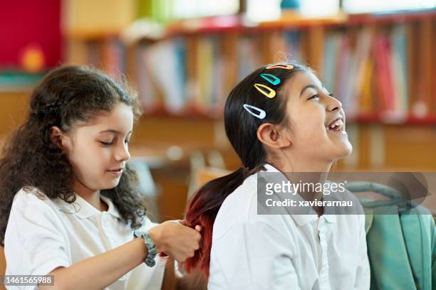 schoolgirls braiding hair - hair clip stock pictures, royalty-free photos & images
