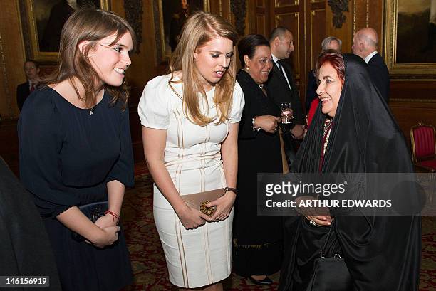 Britain's Princesses Beatrice and Eugenie of York talk with Sheikha Sabika bint Ibrahim al-Khalifa of Bahrain during a reception ahead of a...
