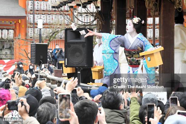 Maiko throw bags containing beans during a bean-scattering ceremony 'Setsubun Festival' at Yasaka Jinja Shrine ahead of the Setsubun, end of winter...