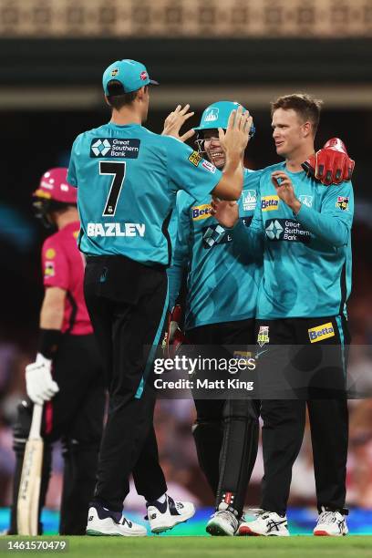 Matt Kuhnemann of the Heat celebrates with team mates after taking the wicket of Daniel Hughes of the Sixers during the Men's Big Bash League match...