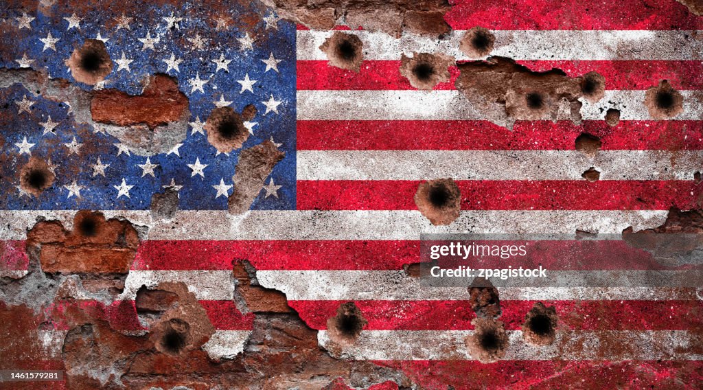 Wall with US flag mural and bullet holes