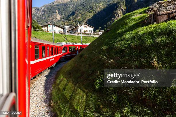 The passage of the Red Train of Bernina in the railway section located near the center of Brusio. Brusio , October 17th, 2021 SPECIAL FEE - CONTACT...