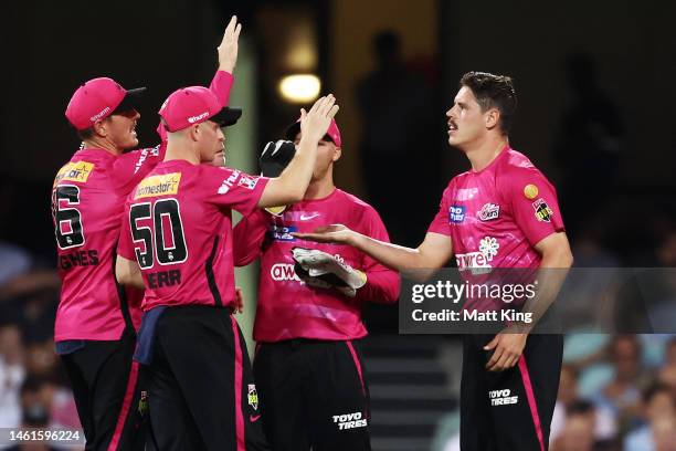 Ben Dwarshuis of the Sixers celebrates with team mates after taking the wicket of Josh Brown of the Heat during the Men's Big Bash League match...