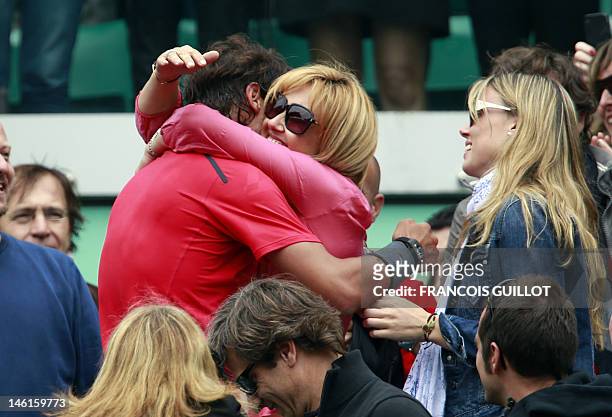 Spain's Rafael Nadal celebrates with his mother Ana Maria Parera , and sister Maria Isabel Nadal and his staff members after winning against Serbia's...