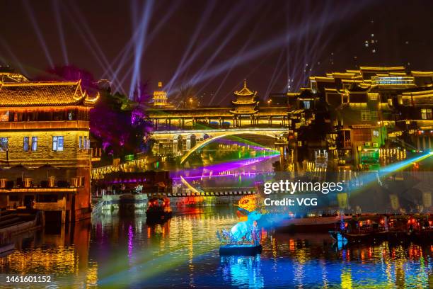 Tourists visit the illuminated Qianzhou Ancient Town to celebrate Chinese New Year, the Year of the Rabbit, at night on February 1, 2023 in Jishou,...