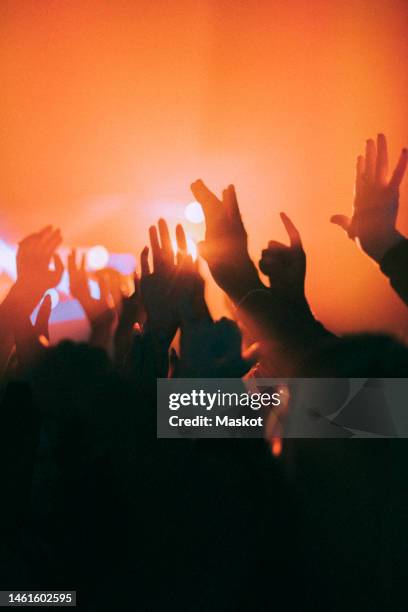 silhouette raised hands of men and women dancing at nightclub - hands in the air party stock pictures, royalty-free photos & images