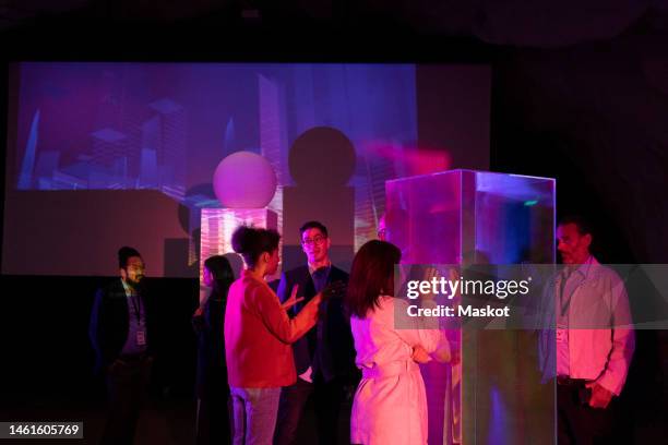 female and male entrepreneurs discussing in seminar during corporate event - tech conference event stock pictures, royalty-free photos & images