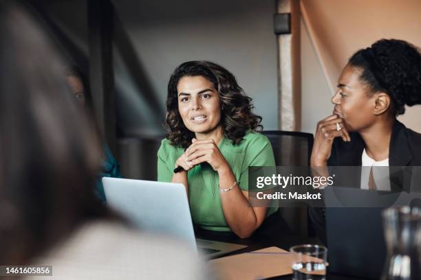 mature businesswoman discussing in meeting with female colleagues at office - indian colleague stock pictures, royalty-free photos & images