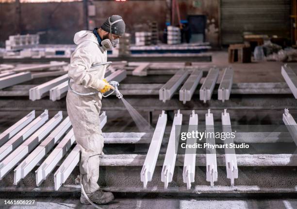 man painting metal in factory - spray gun stock pictures, royalty-free photos & images