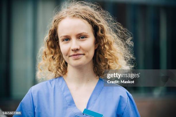 portrait of smiling female nurse with blond hair - nurse headshot stock pictures, royalty-free photos & images