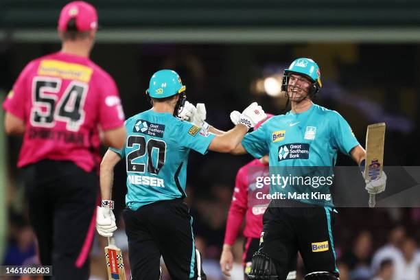 Michael Neser and James Bazley of the Heat celebrate victory during the Men's Big Bash League match between the Sydney Sixers and the Brisbane Heat...