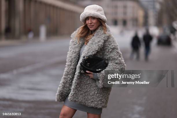 Sonia Lyson seen wearing Louis Vuitton black leather logo pattern bag, Edited grey short knit dress, Monki fluffy grey teddy jacket, H&M beige teddy...