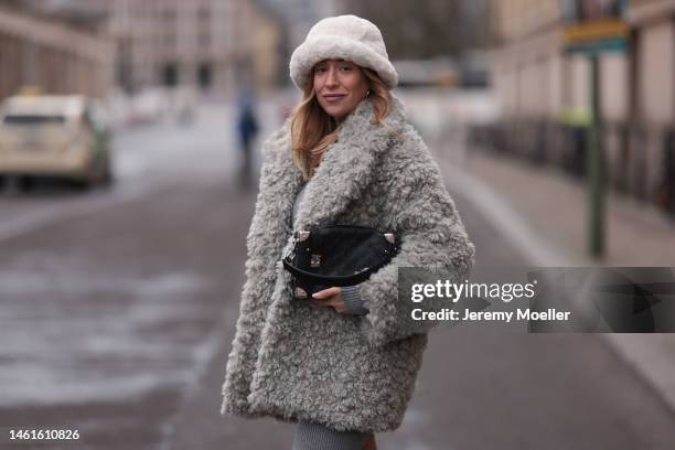 Sonia Lyson seen wearing Louis Vuitton black leather logo pattern bag, Edited grey short knit dress, Monki fluffy grey teddy jacket, H&M beige teddy...