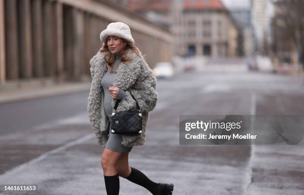 Sonia Lyson seen wearing Louis Vuitton black leather logo pattern bag, Prada black shiny leather loafer, Wolford black transparent socks, Edited grey...