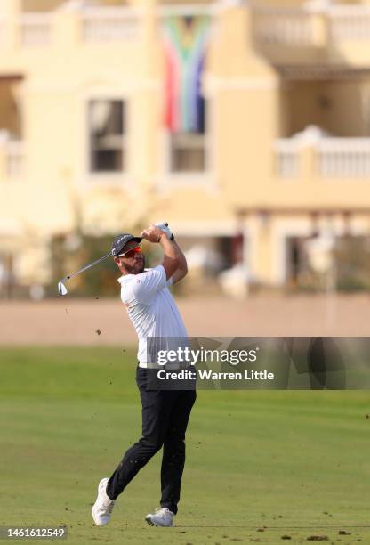 Ockie Strydom of South Africa plays his approach shot on the 13th hole during Day One of the Ras Al Khaimah Championship at Al Hamra Golf Club on...