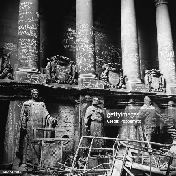 Graffiti written by invading Soviet troops from the Red Army adorn columns and statues within a hall inside the ruined Reichstag building, home of...