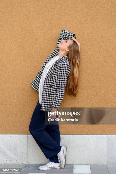 young woman portraits near brown wall - chaqueta a cuadros fotografías e imágenes de stock