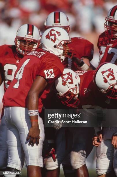 Jamie Barnette, Quarterback of the North Carolina State Wolf Pack calls the play to his offensive line in the huddle during the NCAA Atlantic Coast...