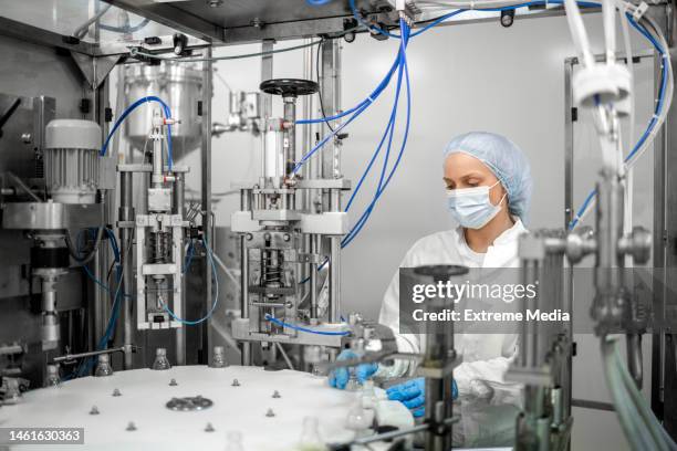 modernizing medication production: pharmaceutical bottle manufacturing machine - drug manufacturing stock pictures, royalty-free photos & images