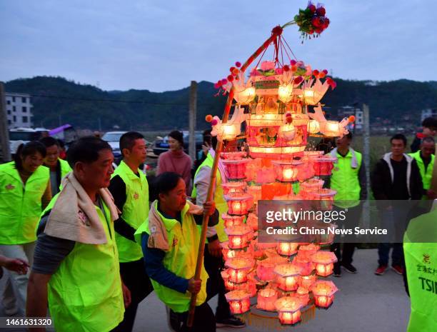Villagers carrying oil lamps parade during a traditional ceremony celebrating Chinese New Year, the Year of the Rabbit, at Zhixi village on February...