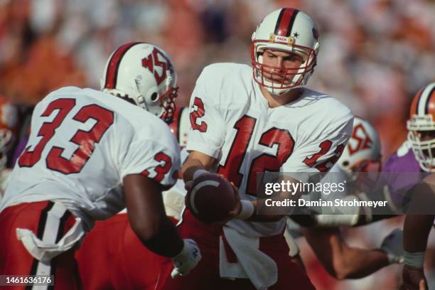 Geoff Bender, Quarterback of the North Carolina State Wolf Pack hands off the football to Running Back Greg Manior during the NCAA Atlantic Coast...