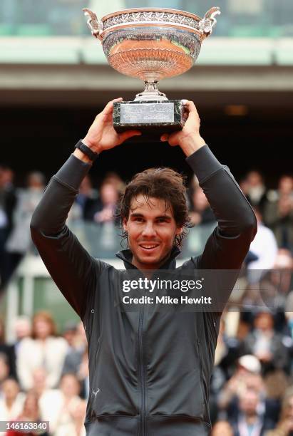 Rafael Nadal of Spain poses with the Coupe des Mousquetaires trophy in the men's singles final against Novak Djokovic of Serbia during day 16 of the...