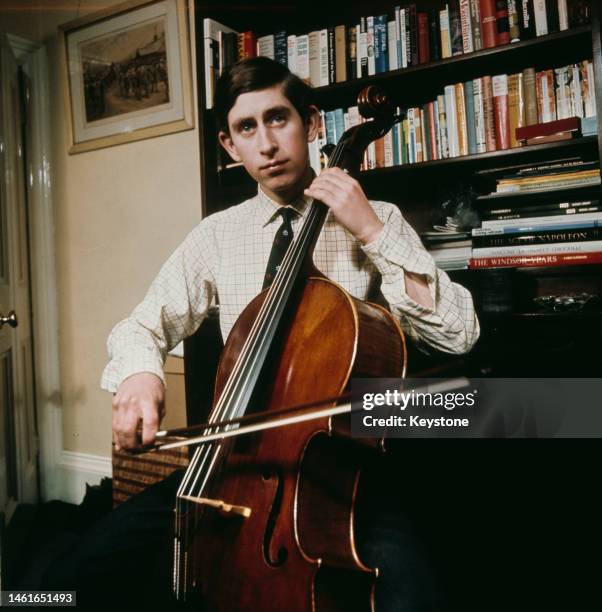 Prince Charles playing his cello in his rooms at Cambridge University in 1967.