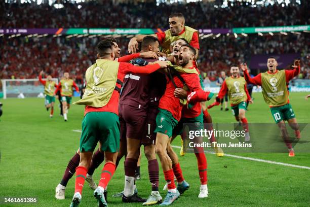 The Moroccan players celebrate after beating Spain on penalties during the FIFA World Cup Qatar 2022 Round of 16 match between Morocco and Spain at...