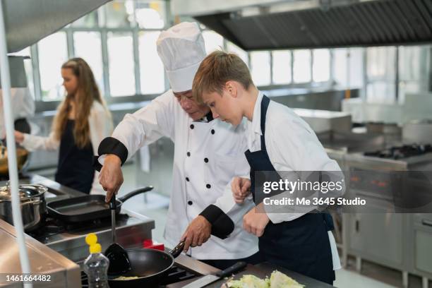 chef teaches students training in cooking in a restaurant. - child chef stock pictures, royalty-free photos & images