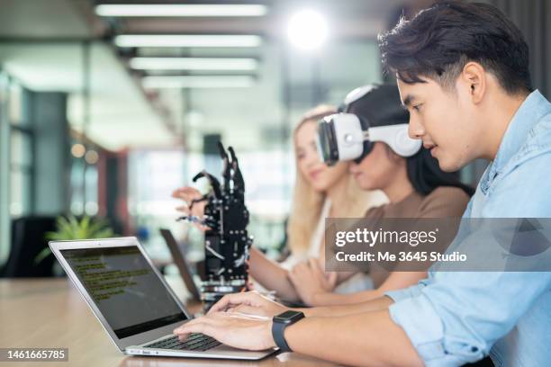 women and men learn computer robot innovations. - machine learning stock pictures, royalty-free photos & images