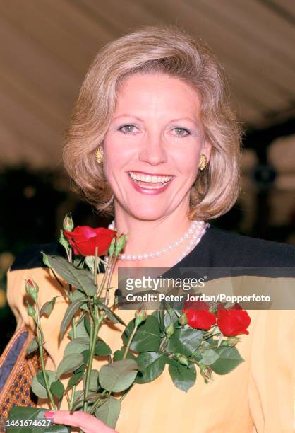 Anna Murdoch, wife of Australian media owner Rupert Murdoch, posed with a bunch of the rose cultivar 'New Times Rose' at Chelsea Flower Show in...