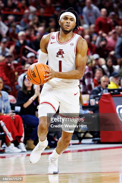 Ricky Council IV of the Arkansas Razorbacks drives to the basket for a reverse dunk during a game against the Texas A&M Aggies at Bud Walton Arena on...