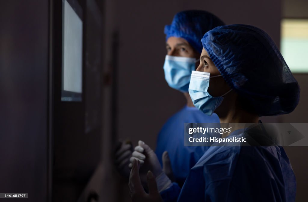 Surgeons looking at the computer monitor in the operating room