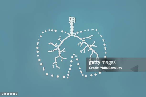 white pills in shape of human lungs - quarantine icon stock pictures, royalty-free photos & images