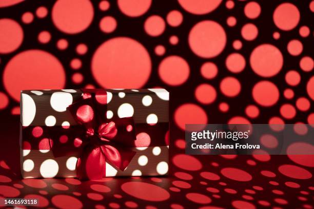 white present box on red background gobo lighting - kaleidoscope heart stock pictures, royalty-free photos & images