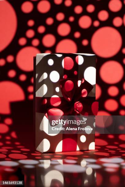 white present box on red background gobo lighting - kaleidoscope heart stock pictures, royalty-free photos & images