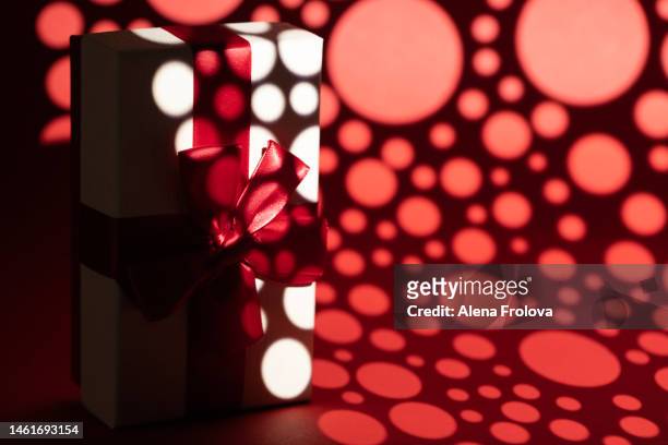 white present box on red background gobo lighting - kaleidoscope heart stock pictures, royalty-free photos & images